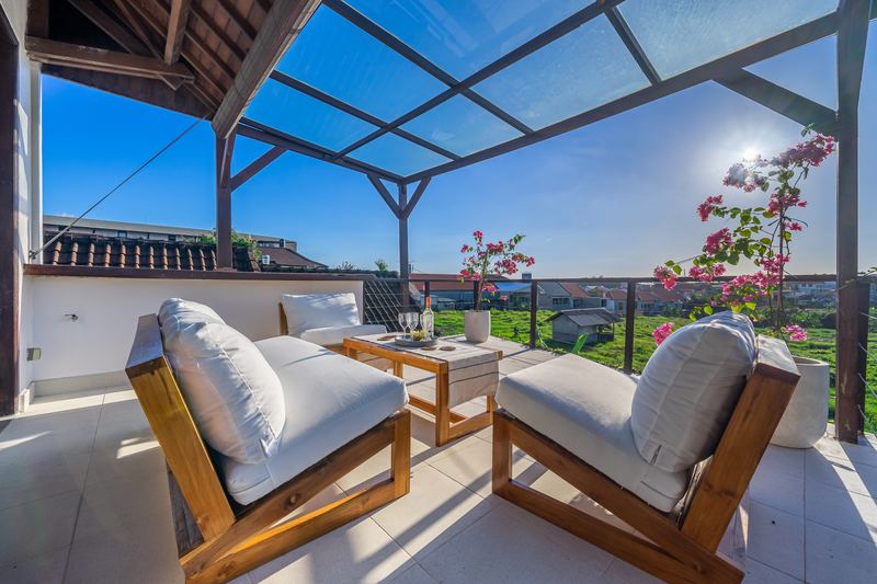 Rooftop terrace with daybeds, bougainvillea and open views across Berawa