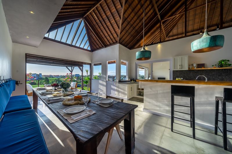 Dining table and kitchen bar with rice-field views