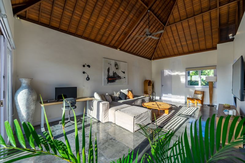 Second living area with tropical planting and open doors to the terrace