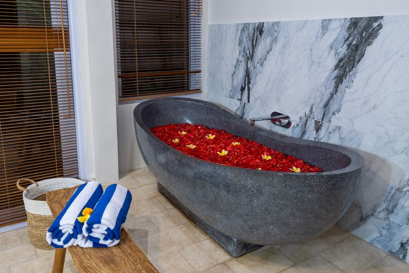 Marble ensuite bathroom with freestanding carved stone bathtub