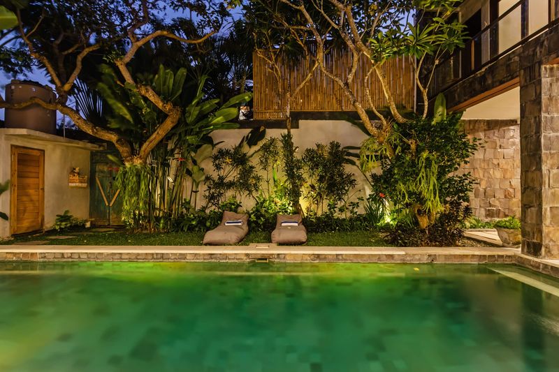 Pool and garden lit at night