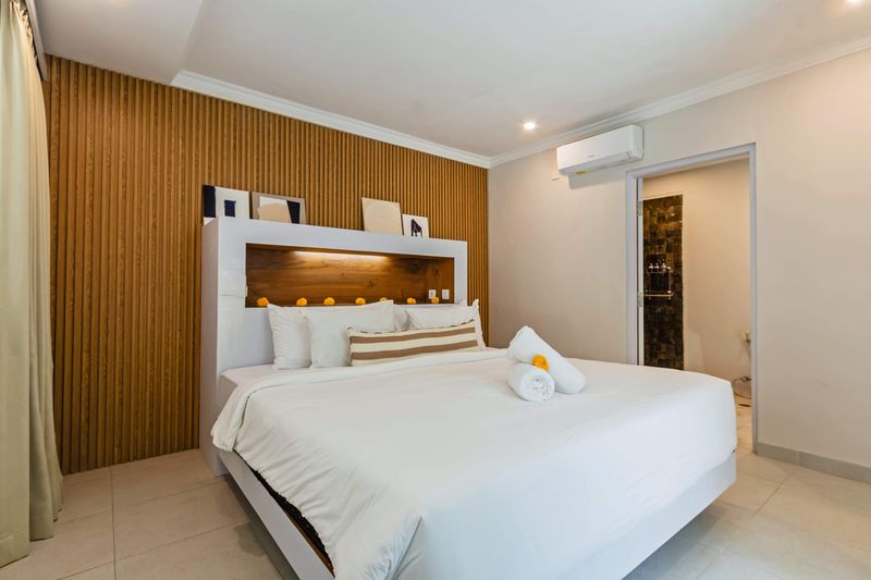 Bedroom with built-in headboard and reading lights
